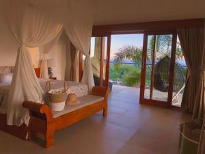 a bedroom with a bed with a view of the ocean at Maya Villa in Candidasa +135 photos