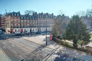 an empty street in front of a large building at President Hotel in London