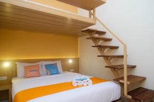 a bedroom with a bed with a bunk ladder at Sans Hotel Aurum Majapahit Semarang in Semarang