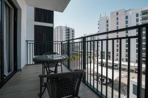 a balcony with a table and chairs on a building at Top Rated Family Suite - Yas in Abu Dhabi