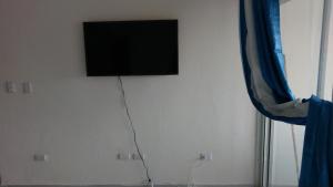 a flat screen tv hanging on a wall at tropicana sur apt221 in Sosúa