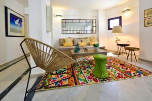 a living room with a couch and a table and a rug at Kalidon beach Hotel in Kokkari
