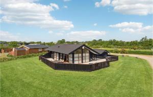 a house on a grassy field with a house at Stunning Home In Sydals With Sauna in Neder Lysabild