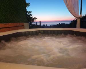 a jacuzzi tub with a view of the sunset at Annas Glamping in Batumi