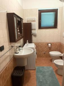 a bathroom with a sink and a toilet at Il mare di Matera in Policoro