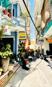 a city street with motorcycles parked in front of buildings at EVA Hotel in Hue