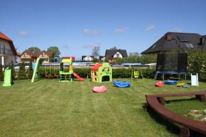 a group of playground equipment in a yard at Dworek Łeba i Domki Ranczo Itrich in Łeba