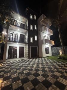 an empty courtyard in front of a building at night at DreamScape Holiday Apartment Kalutara in Kalutara