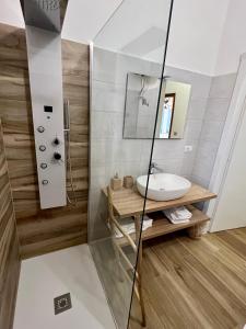 a bathroom with a sink and a mirror at Terrazze Sul Mare in Pozzallo