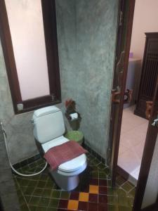 a bathroom with a toilet in a room at Smile Beach Boutique Resort in Chao Lao Beach