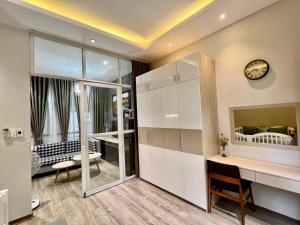 a room with a desk and a clock on the wall at Kata Home in Danang