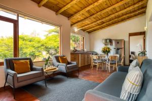 a living room with a blue couch and chairs at Beautiful & Warm Cabin with Lakeview 3BR 2 5BA in Valle de Bravo