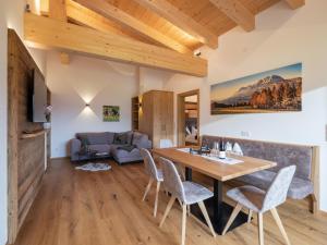 a living room with a wooden table and chairs at Bauernhof Mühlbichl in Söll