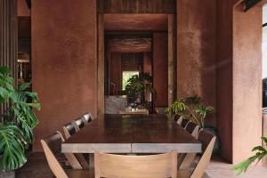 a dining room with a table and chairs at Further Hotel in Canggu