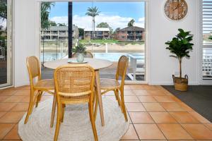 a dining room with a table and chairs at Stunning Mooloolaba Waterfront Home -10 guests ZB1 in Mooloolaba