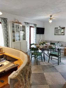 a kitchen and living room with a table and chairs at Holiday Home Bukovac in Klimno