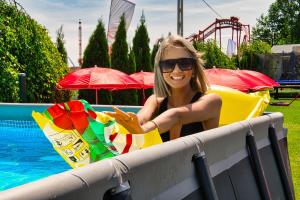 a woman sitting on a raft next to a pool at Holiday Park Zator in Zator