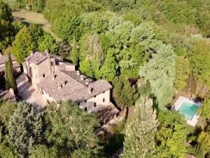 an aerial view of an old house in the forest at Unique country house in an old hamlet in Monte Castelli