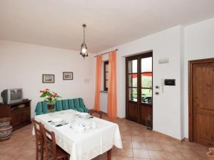 a dining room with a white table and chairs at Stunning Farmhouse in Passignano with Pool in Passignano sul Trasimeno