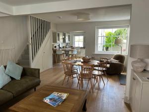 a living room with a couch and a table at Billie's seaside retreat in Lyme Regis