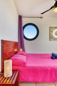 a bedroom with two beds and a window at Bleu Horizon in Saint-Leu