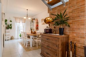 a kitchen and dining room with a brick wall at Old Village House in Suza