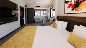 a bedroom with a large white bed and a living room at La Vida Suite in Beirut +36 photos