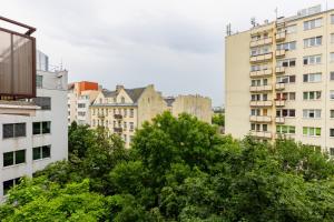 a city skyline with tall buildings and trees at Cozy & Stylish Studio Ochota 1,5 km to Złote Tarasy by Renters in Warsaw