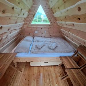 a bed in the middle of a tiny house at Glamping - Kamp Steska in Žalec