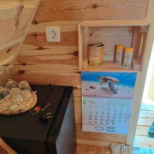 a kitchen with a calendar on the wall and a stove at Glamping - Kamp Steska in Žalec