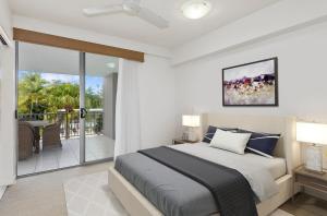 a bedroom with a large bed and a balcony at Drift North Beachfront Apartments - Private Apartments in Kingscliff +250 photos