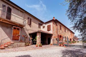 a large brick building with a staircase next to it at B&B Il Pozzo in Sinalunga