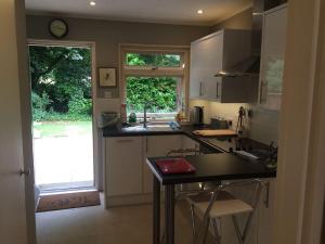 a kitchen with a counter and a sink and a window at Whole of Yew Tree Cottage Sleeps 4 in Maidford