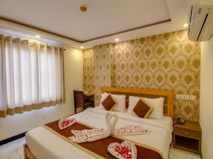 a hotel room with a bed with two towels on it at Jasoda Heritage By Keshav Global Hotels in Jaipur