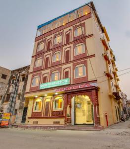 a large building with a store in front of it at Jasoda Heritage By Keshav Global Hotels in Jaipur