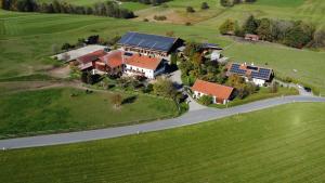 an aerial view of a house with solar panels on it at Fürstnerhof Chiemsee in Rimsting