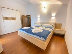 a bedroom with a bed with blue sheets and white towels at Villa Family in Medulin