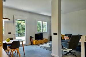 a living room with a couch and a table and a tv at Kastron Views in Chios