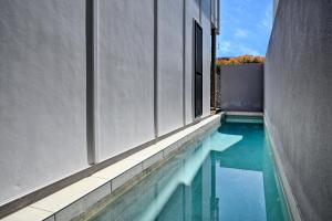 a swimming pool in the middle of a building at Stylish, Beachside 4 b/r Dream Home - 8 guests ZD7 in Kawana Waters