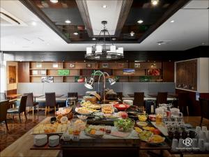a buffet of food on a table in a restaurant at Daiwa Roynet Hotel Osaka-Kitahama in Osaka