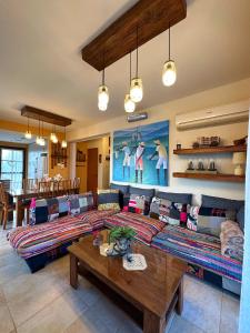 a living room with a couch and a table at Sotira Agia Napa Luxury House in Ayia Napa