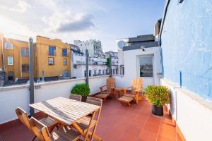 a patio with a table and chairs on a balcony at Homie Suites - Historical Apartment Nearby Galata Tower in Istanbul