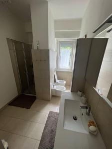 a bathroom with a sink and a toilet in it at Da Emma e Carlo - homy apt. in Tirano +11 photos