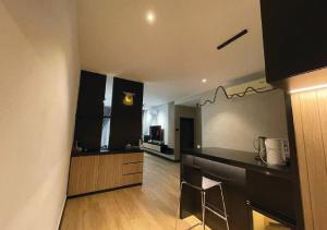 a kitchen with black cabinets and a counter top at D Secret Homestay 2BR Condo Luxury in Johor Bahru