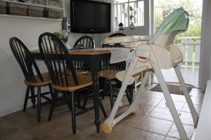 a baby stroller standing next to a dining room table at Bergland 10 - close to the center of Kragerø in Kragerø