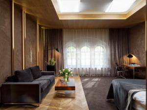 a living room with a couch and a table at City Park Hotel & Residence in Poznań