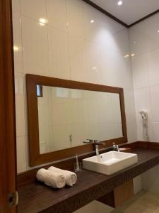 W łazience znajduje się umywalka i lustro. w obiekcie Hotel & Villa Bukit Indah Saumlaki by LeGreen 