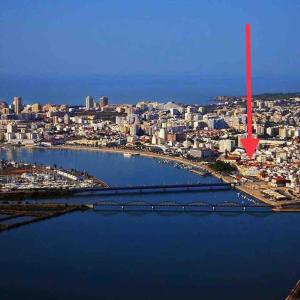 an aerial view of a city with a red arrow at Tiny Home in by Portimao Promenade Pier in Historic Quarter in Portimão