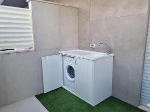 a washing machine with a sink in a laundry room at La Casa di Mimi in Monopoli