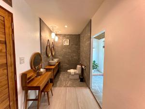 a bathroom with a sink and a toilet and a mirror at Villa Vara - Tropical Pool Villa in Ao Nang Beach +88 photos